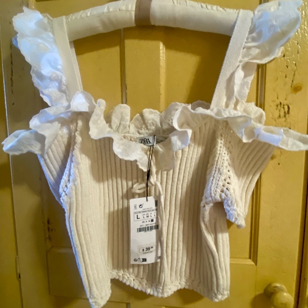 Cream colored, cotton, cropped, partially off the shoulder sweater.